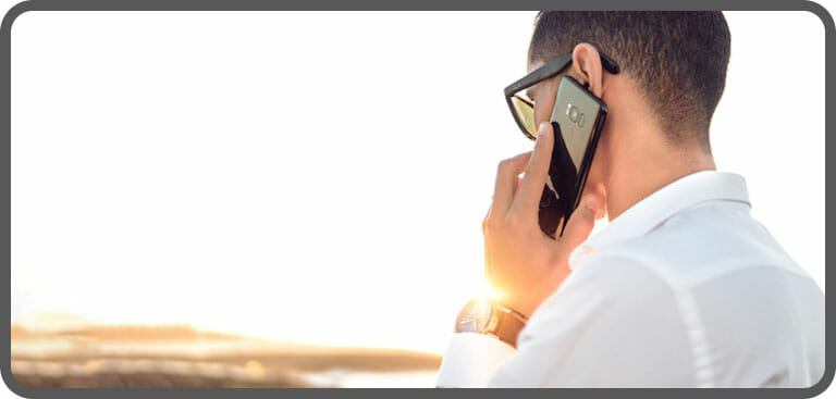 Male employee using VoIP mobile phone remotely