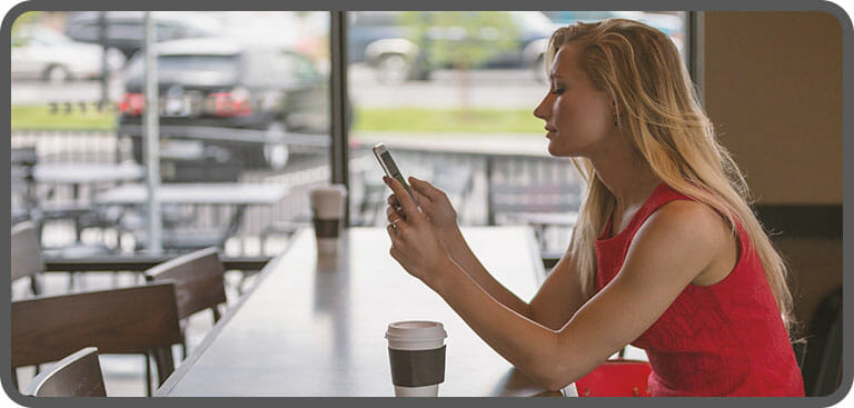 Remote worker using business mobile with landline number in a cafe