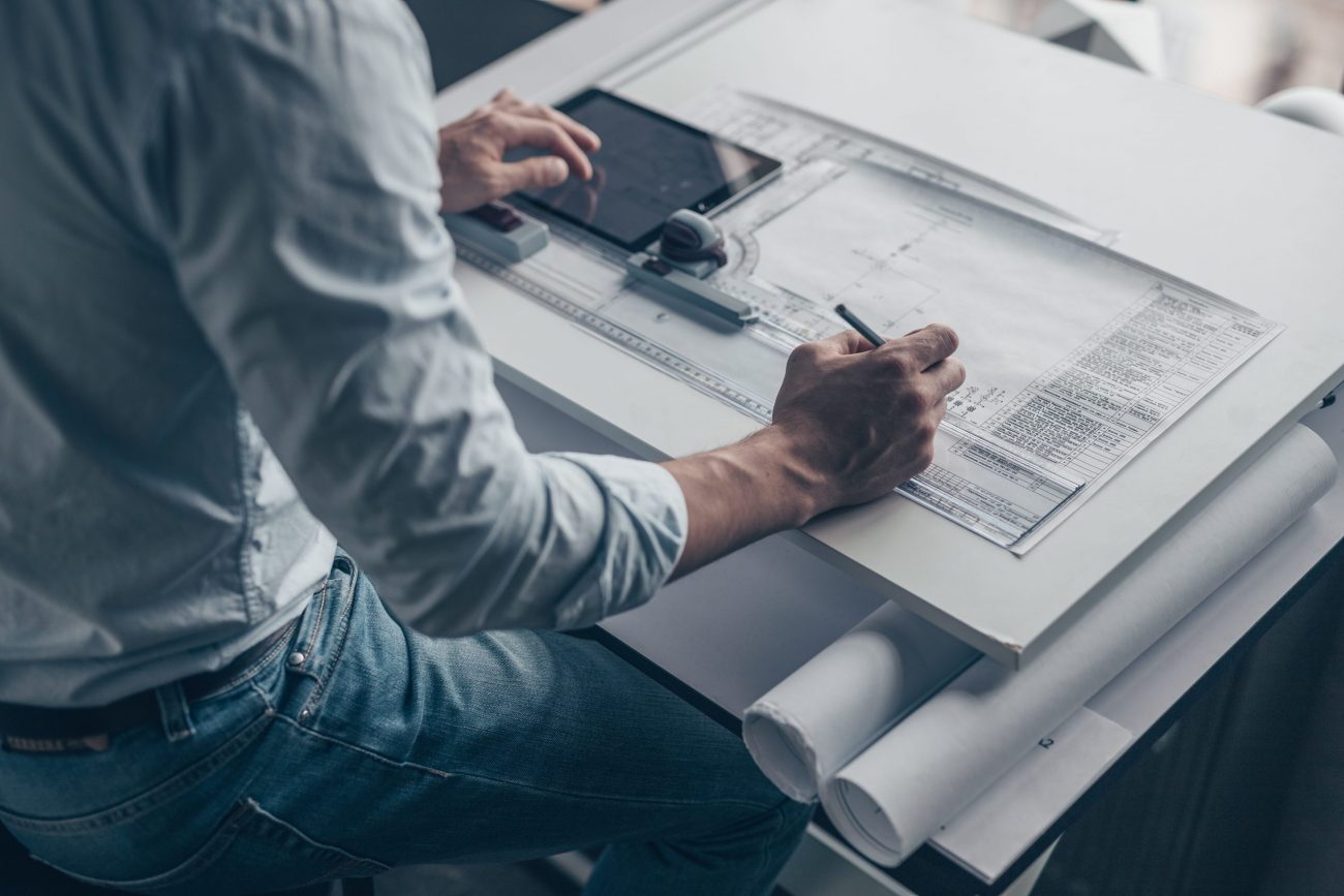 Young architect with a tablet and tools in the workplace